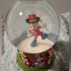 Glass Mickey mouse snow globe with all of the characters on the bottom